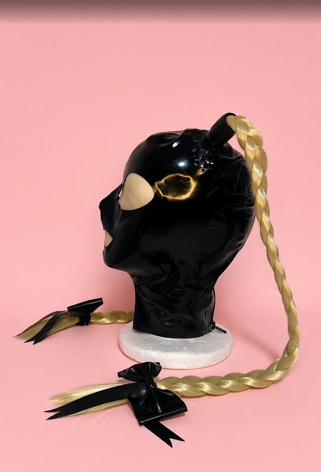 Feminine black latex hood with blonde braids, side view
